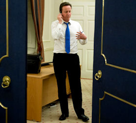 Prime Minister David Cameron speaking on the telephone in 10 Downing street (Reuters)