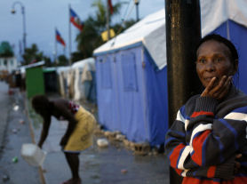 Port-au-Prince quake survivor looks on as rain pours (Reuters)
