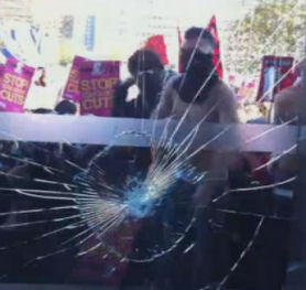 Student tuition fees march: smashed window at Tory HQ.