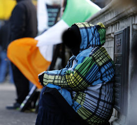 Woman begs for change in Dublin as Ireland considers bank EU aid (Getty)