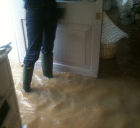 David Lorimer stands in his flooded shop