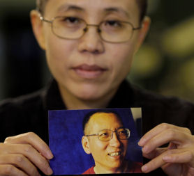 Liu Xiaobo's wife clutches a photo of him