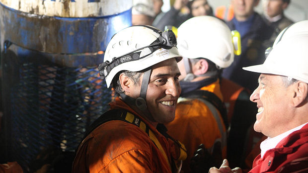 Chile's President Pinera greets rescuer Gonzalez after he emerges last from the San Jose mine to successfully end rescue operations in Copiapo
