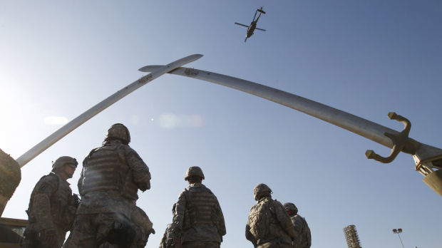 Iraq war files: US troops look up at a US Apache helicopter. (Reuters)