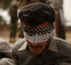 Iraq war files: a man blindfolded during a raid. (Getty)