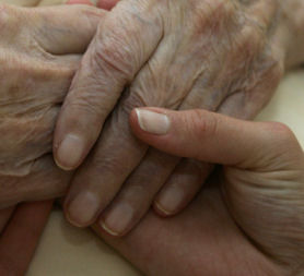 A young carer hold the hands of an elderly person. The government is considering bringing in a care credit scheme for people who volunteer to help the elderly or disabled (credit:Reuters)