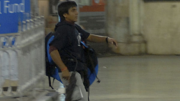 Gunman Mohammad Ajmal Kasab walks in the premises of the Chhatrapati Shivaji Terminus in Mumbai. (Reuters)