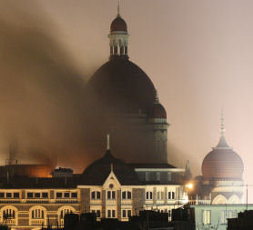 Smoke rises from the Taj Hotel in Mumbai, November 2008. Gunmen killed at least 80 people in a series of attacks. (Reuters)