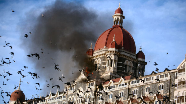 Pigeons fly near the burning Taj Mahal hotel following the 2008 Mumbai attacks. (Reuters)