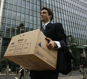 A worker carries a box out of the U.S. investment bank Lehman Brothers in London