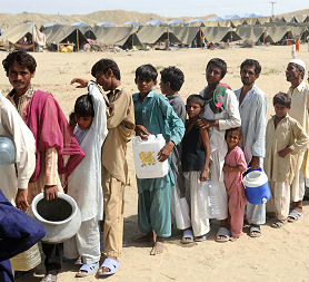 Pakistanis displaced by floods queue for water at an army-run makeshift tent camp in Sehwan, Sindh province, on September 22, 2010