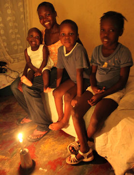 Landina's mother at home in Haiti with her other children