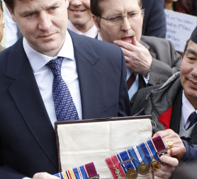 Nick Clegg admiring Gurkha's medals (credit: reuters)