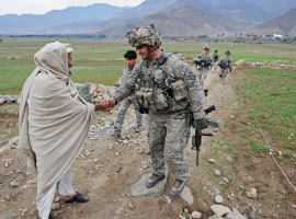  A US soldier shakes hands with a villager (credit: Getty)