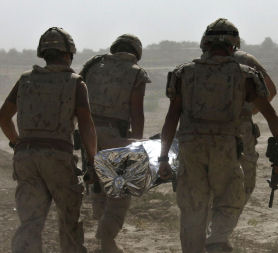 Soldiers carry an injured colleague (picture: Reuters)