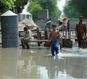 People affected by the Pakistan floods rescue their belongings from the floodwaters