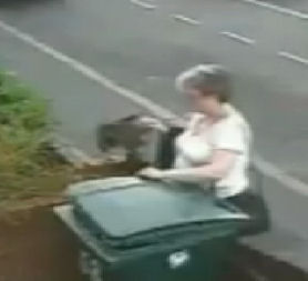 CCTV of a woman accused of putting a cat into a wheelie bin