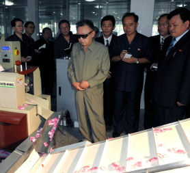 Kim Jong-il visiting a North korean factory in a photograph released today as he visited China (Credit: Reuters)