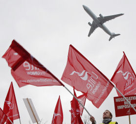 BA strikers and plane - Reuters