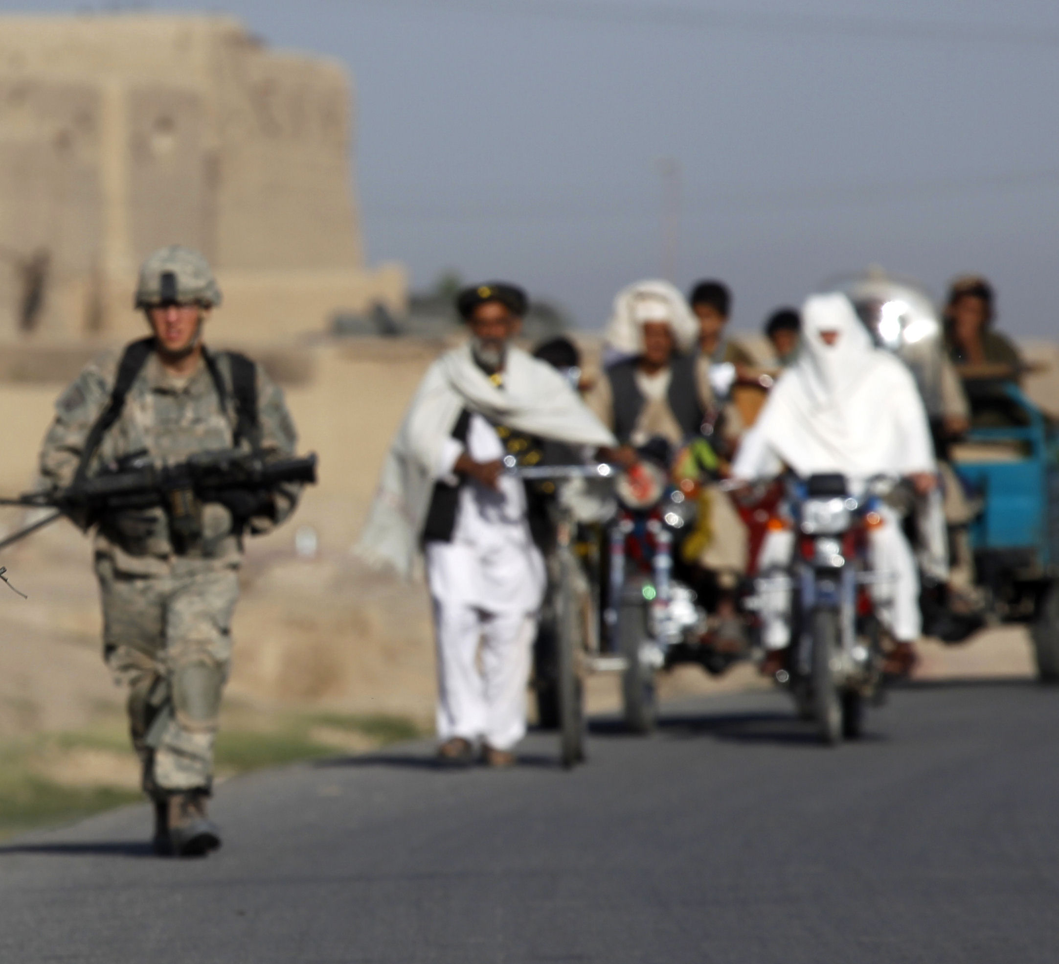 US soldiers on patrol near Kandahar are followed by civilians (credit: Reuters)