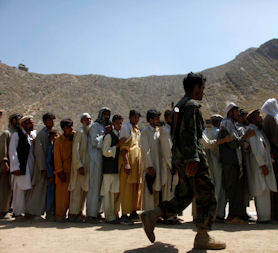 Afghan civilians queue for supplies (Reuters)
