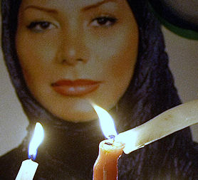 Candles lit in front of a picture of Neda Agha-Soltan (credit: Getty images)
