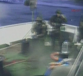 Turkish TV pictures show Israeli troops trying to bring the aid ship under control.