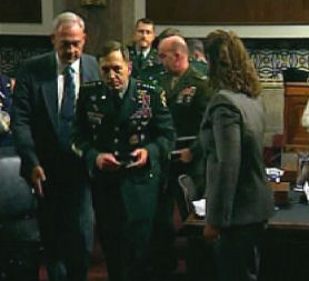 General David Petraeus is led away after collapsing