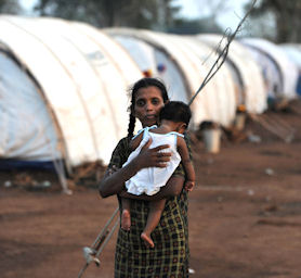 A displaced Tamil woman holds her baby in Sri Lanka (Source: Getty)