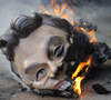 Tony Blair mask burnt during protest outside the Iraq inquiry. (Credit: Getty)