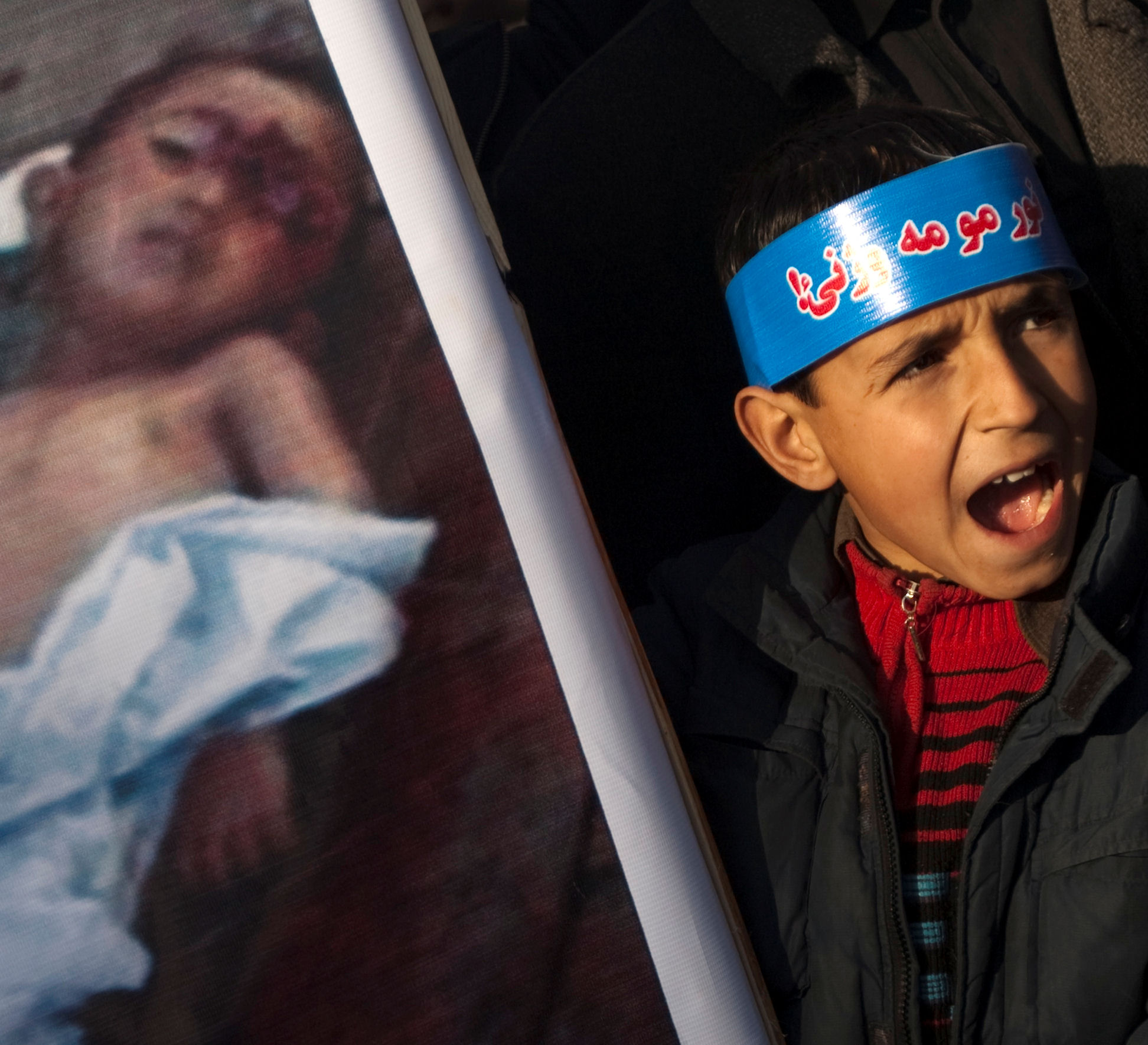Afghan child protest killing of civilians in airstrike (credit - Reuters)