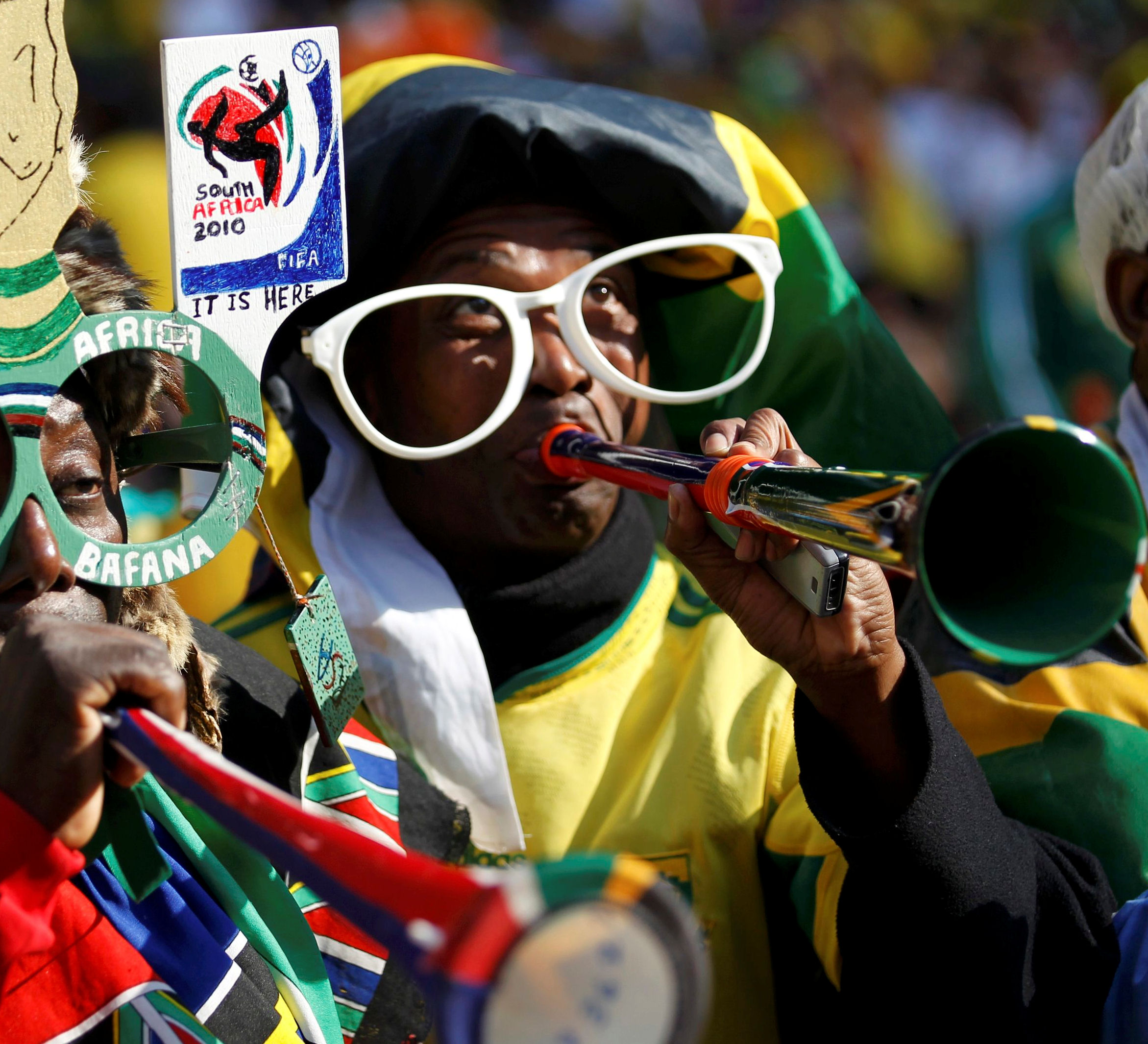 Supporters play vuvuzela trumpets (credit - Reuters)