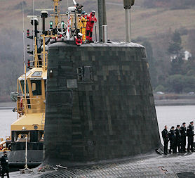 As the government denies planning to delay the renewal of the Trident nuclear deterrent, crew from HMS Vengeance look out from the conning tower as they return along the Clyde river to the Faslane naval base near Glasgow (Reuters)