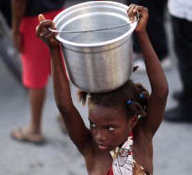 A girl in Haiti with a bucket of water (picture: Reuters)