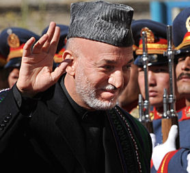 Afghan President Hamid Karzai passes an honour guard in Kabul as he arrives for his swearing in ceremony as the country&apos;s president for another five years. (Credit: Getty)
