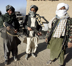 Alleged members of the Taliban pose with weapons (Reuters)