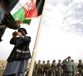 The Afghan flag is raised during an official ceremony in Marjah on February 25, 2010. (Credit: Getty)